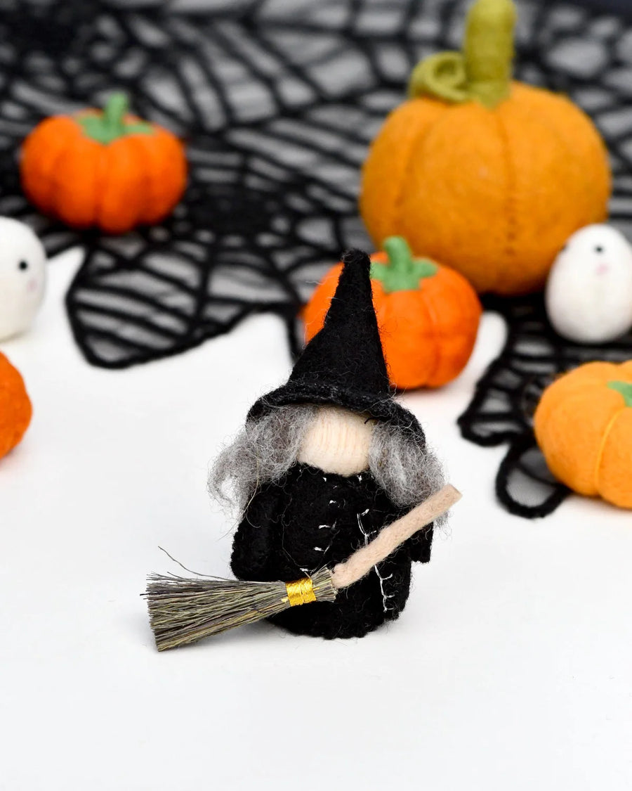 Close view of the cloaked witch peg doll showing the felt and the birch body