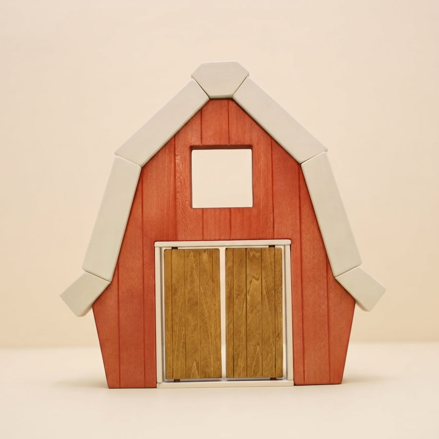 Wooden barn front with a pitched white roofline and wide sliding doors