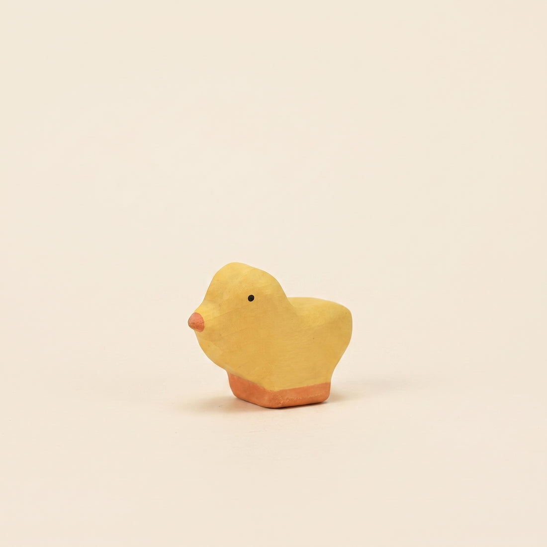 Mako Toys wooden chick, a small yellow bird with an orange beak on a painted base