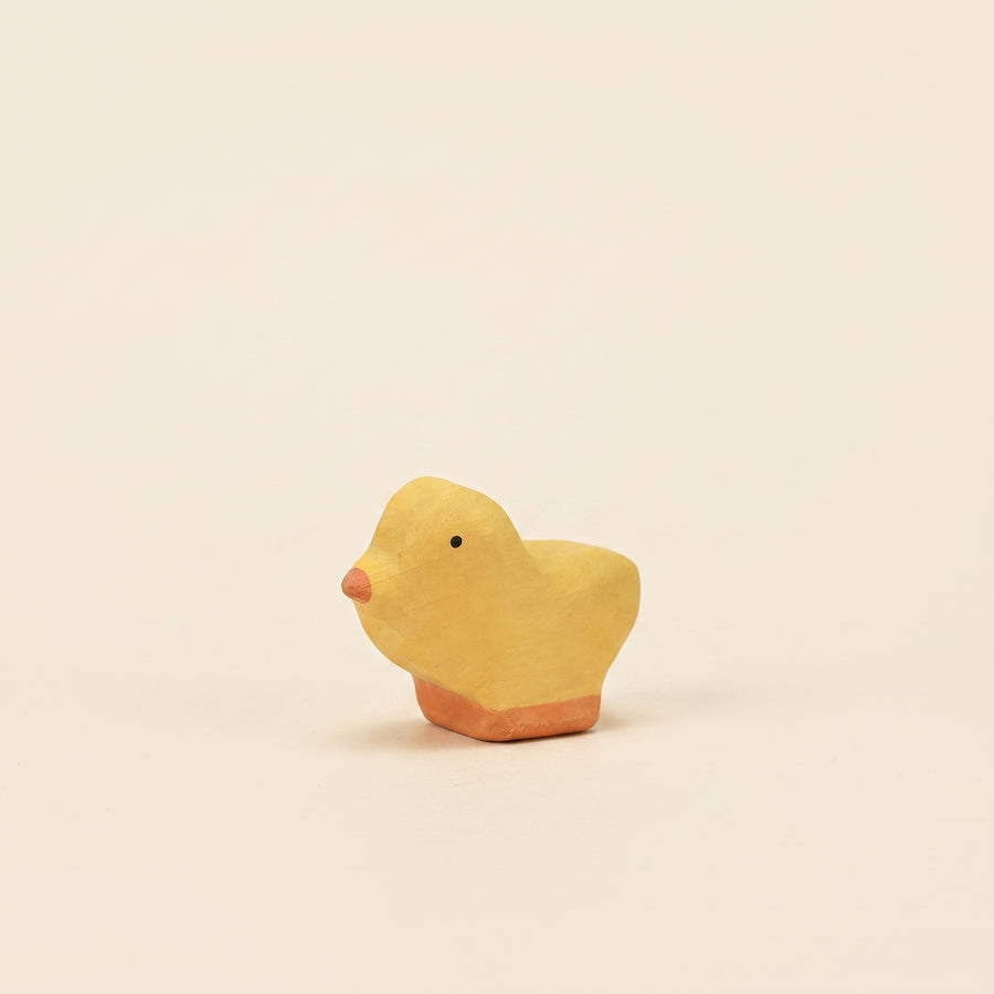 Mako Toys wooden chick, a small yellow bird with an orange beak on a painted base