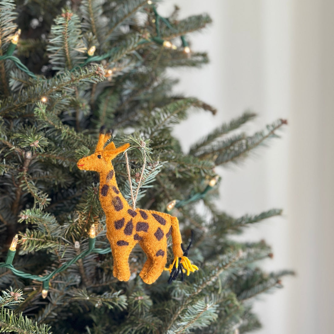 Felt Ornament - Giraffe, a wool felt ornament by Ganapati Crafts Co., needle-felted and hand-stitched in Nepal