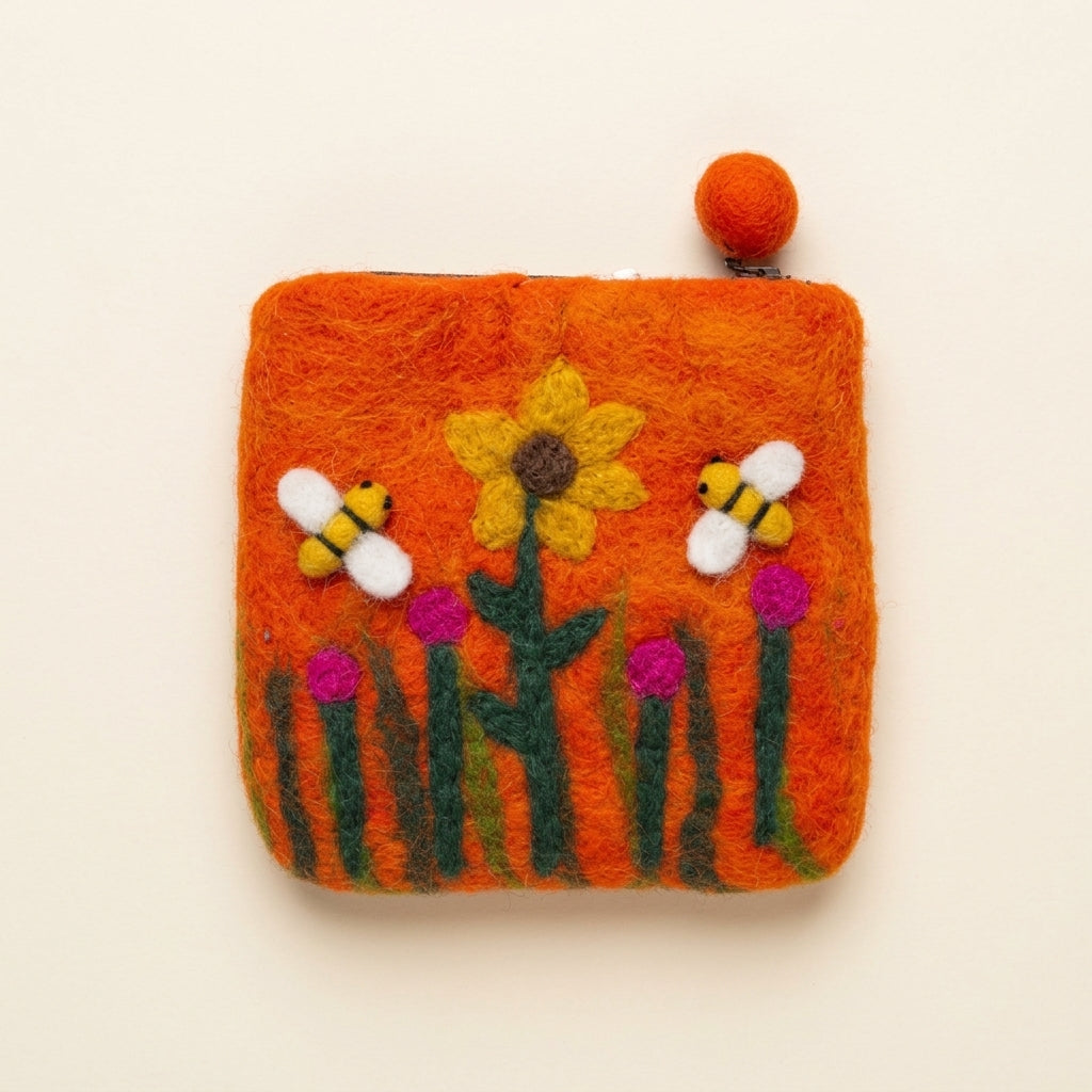 Orange hand-felted wool purse with a zip and felt-ball pull, a yellow sunflower, two felt bees and pink flowers on the front
