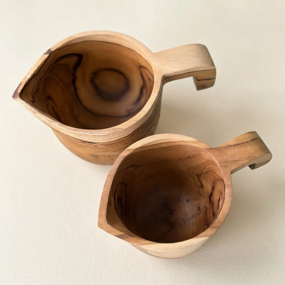 Medium and large teak pouring jugs from above