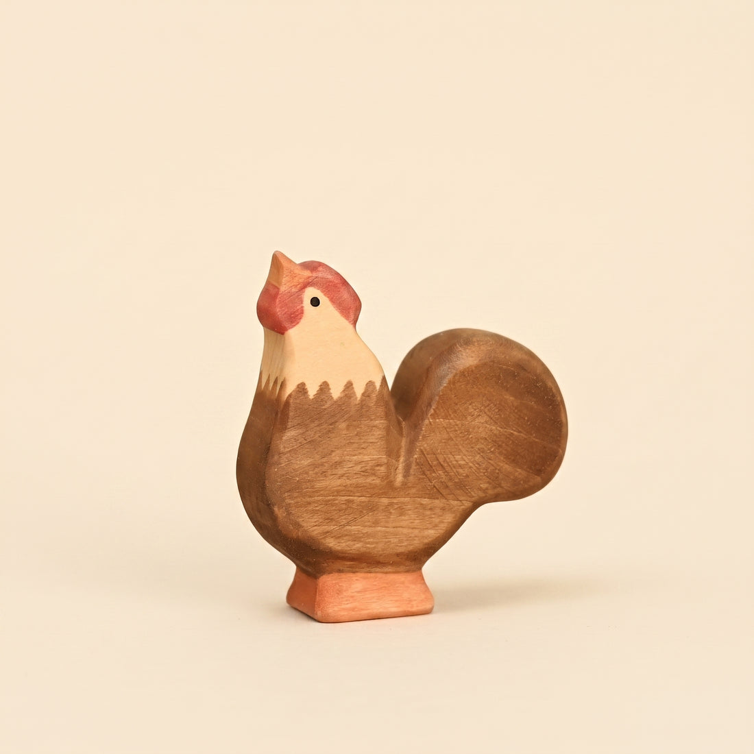 Mako Toys wooden rooster with a red comb and upright tail, standing on a painted base