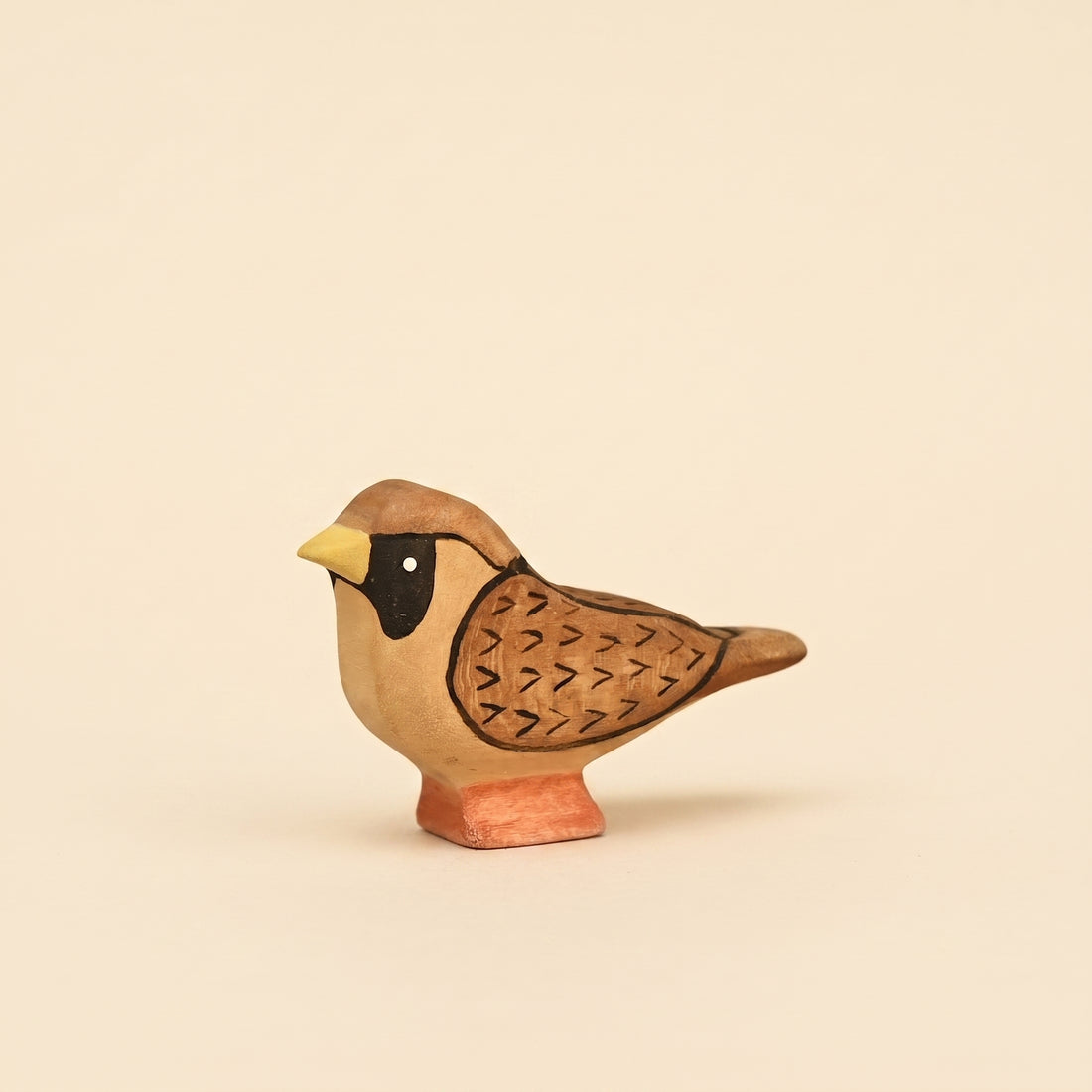 Mako Toys wooden sparrow with a black mask and painted wing markings on a small base