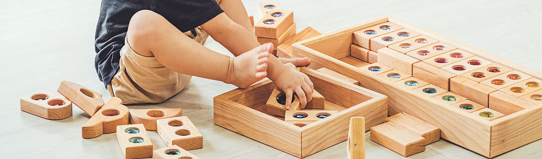 Bauspiel wooden blocks with faceted acrylic gems catching colored light