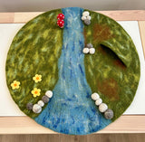 Whimsical felt play mat, storybook-style landscape · view 1