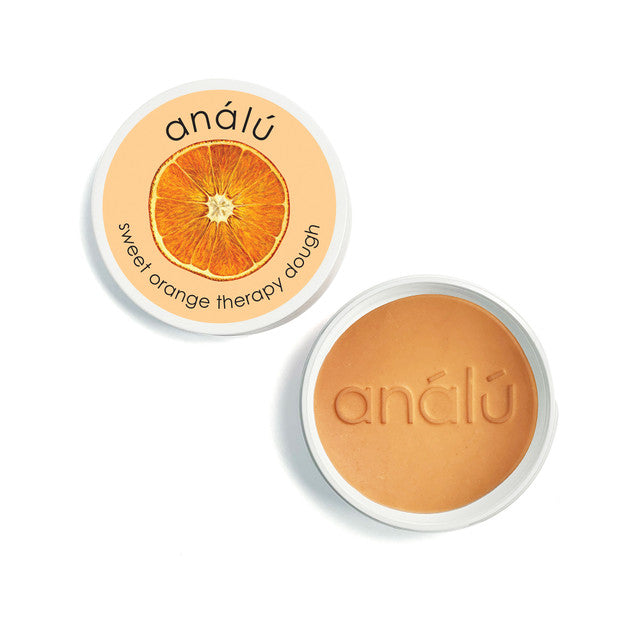 Analu orange therapy dough puck in a printed tin