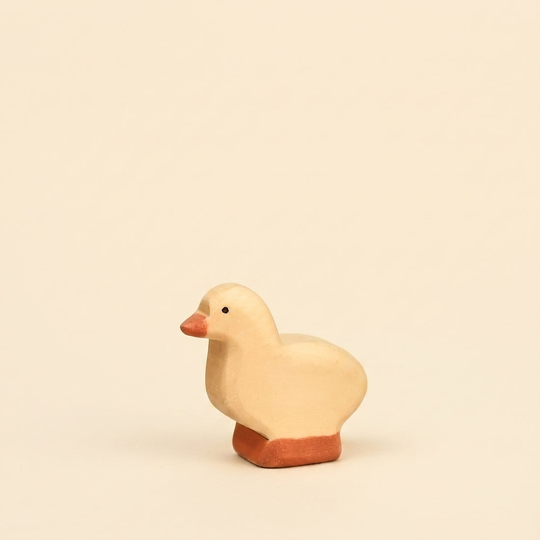 Mako Toys wooden gosling, a small pale goose chick standing on an orange base