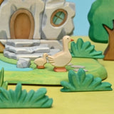 Wooden gosling shown in profile, hand-painted in pale cream and orange · view 2