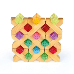 Luminous Blocks set into the openings of wooden building blocks, forming a wall of lit windows.