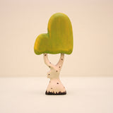 Wooden birch tree with a pale white trunk and a soft yellow green canopy · view 1