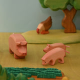 Wooden pecking hen beside chicks in a small-world farmyard scene · view 3