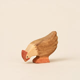 Mako Toys wooden hen with its head lowered to peck, painted brown and cream with a red comb · view 1