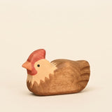 Mako Toys wooden hen sitting with feathers tucked in, painted brown and cream with a red comb · view 1
