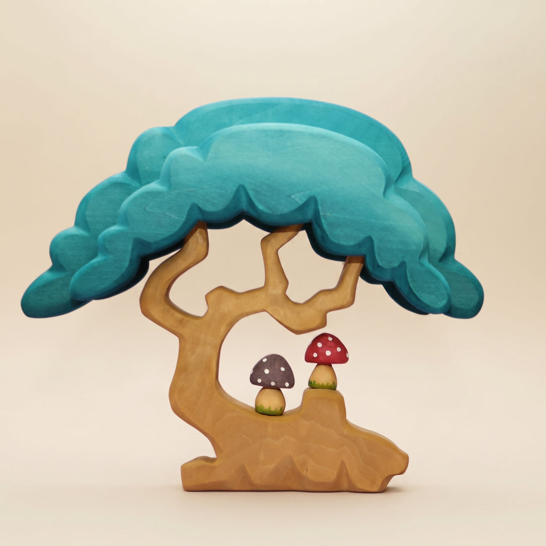 Wooden tree with a deep turquoise canopy, a hollow at the base, and a toadstool beside the roots
