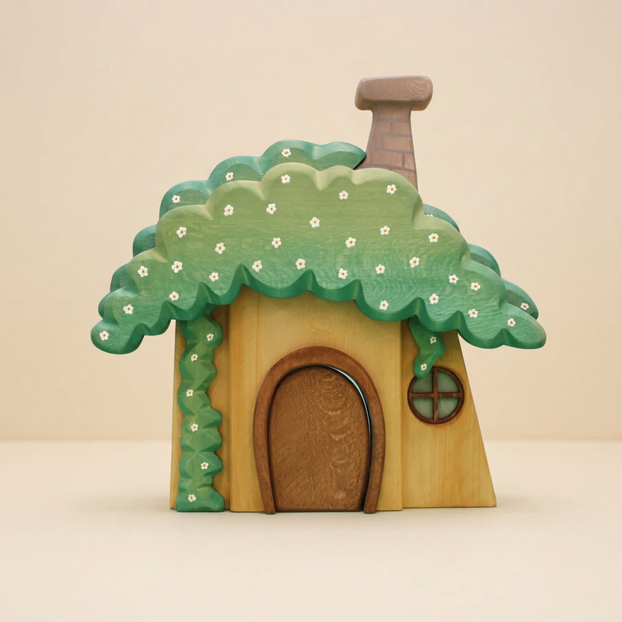 Wooden dwarf's house with a mossy green roof, white flowers, a rounded door, and a chimney