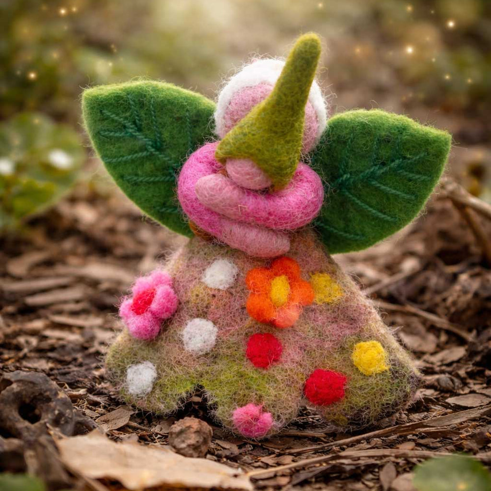 Felted fairy figurine with floral dress on a natural background