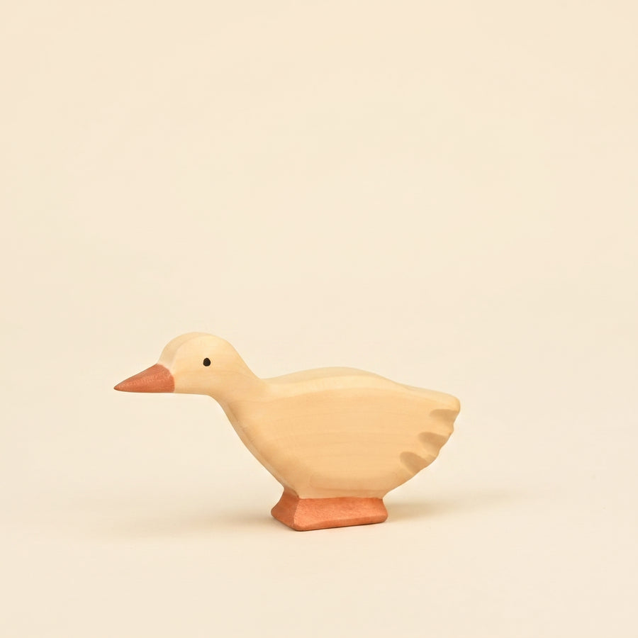 Mako Toys wooden goose with its head lowered, hand-painted in cream with an orange bill