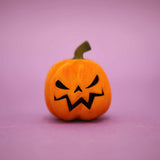 Wooden carved pumpkin with black triangle eyes and a jagged grin · view 1