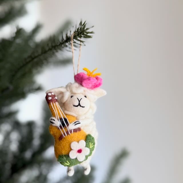 Handmade felt hula sheep ornament holding a ukulele