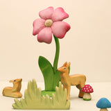 Second view of the wooden flower showing the carved petals and green leaves · view 2