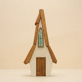 Wooden house with a steep roof, a tall arched window, and a door that lifts out · view 1