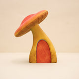 Tall wooden toadstool with a red cap and an arched door cut into the stem · view 1