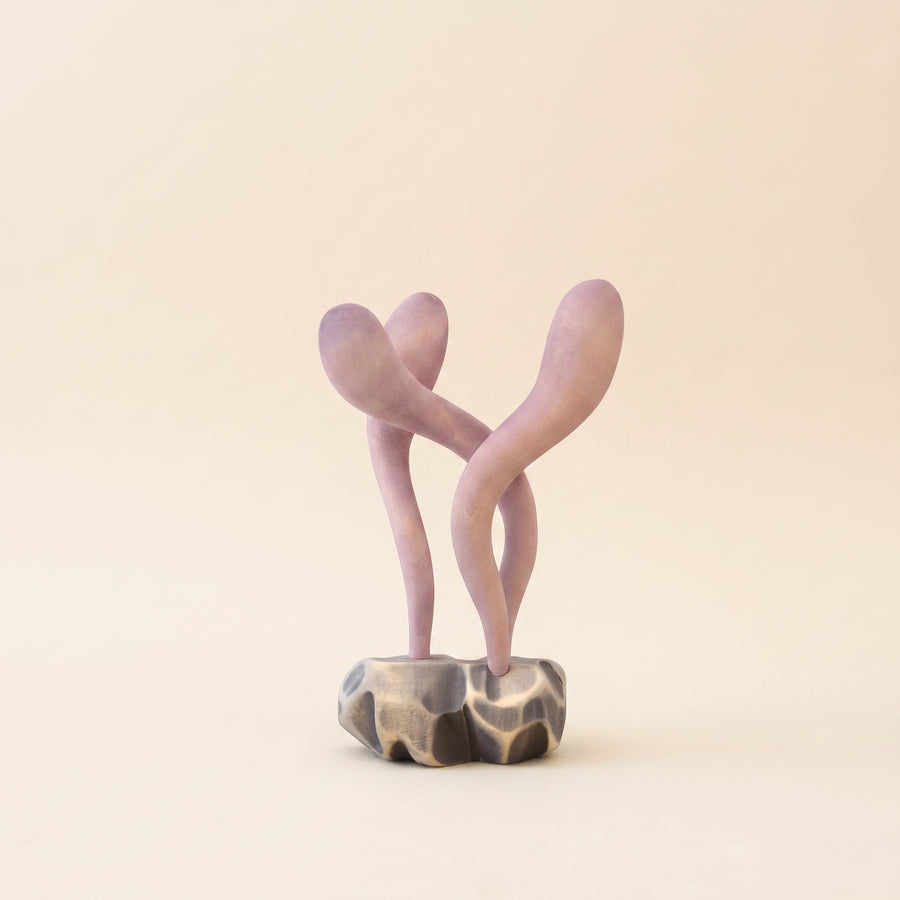 Wooden ocean plant with two pale pink stalks curving away from each other on a small base