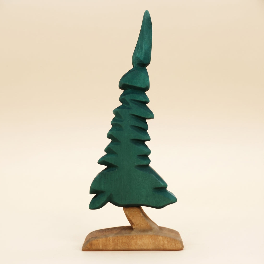 Wooden spruce tree carved in dark green tiers on a short bare trunk and base