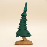 Wooden spruce tree carved in dark green tiers on a short bare trunk and base · view 1