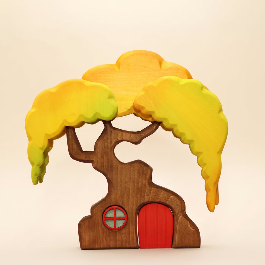 Wooden treehouse with a yellow canopy, a round window, and a red door that lifts out of the trunk