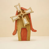 Wooden windmill with four pale sails on a red and timber tower · view 1