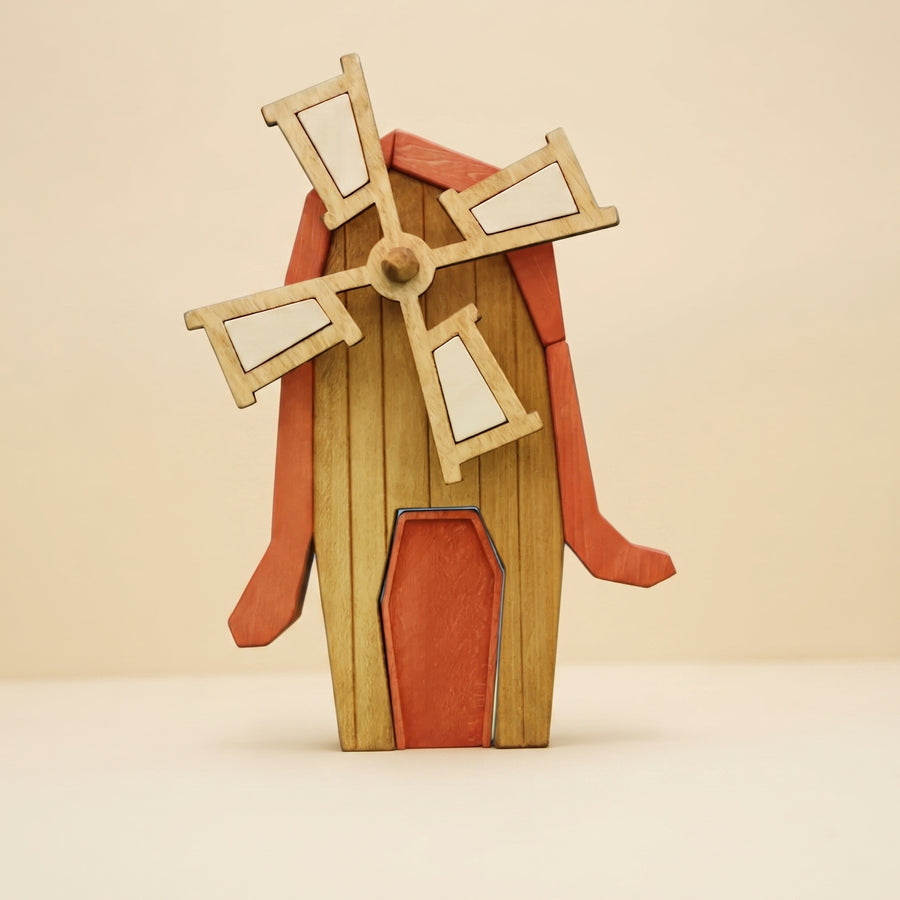 Wooden windmill with four pale sails on a red and timber tower