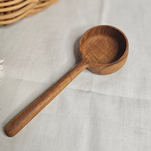 Teak pot scoop with a deep rounded bowl on a long handle