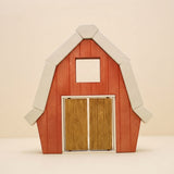 Wooden barn front with a pitched white roofline and wide sliding doors · view 1
