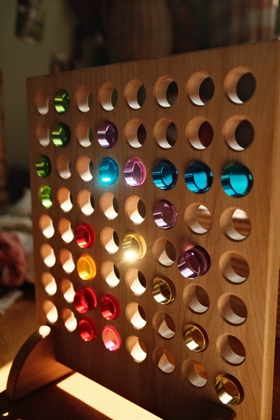 Bauspiel game board with glowing lucent cylinders in rainbow colors