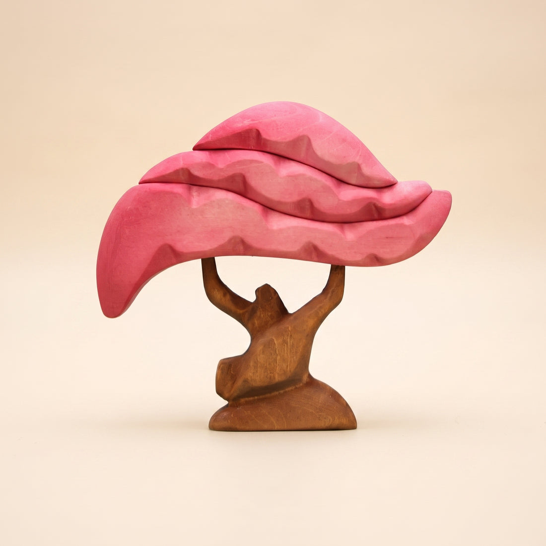 Wooden cherry tree with a pink blossom canopy carved in layers on a brown trunk