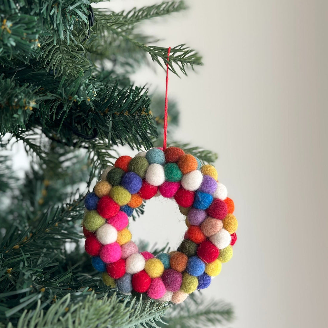 Felt Ornament - Mini Pompom Pompom Wreath, a wool felt ornament by Ganapati Crafts Co., needle-felted and hand-stitched in Nepal