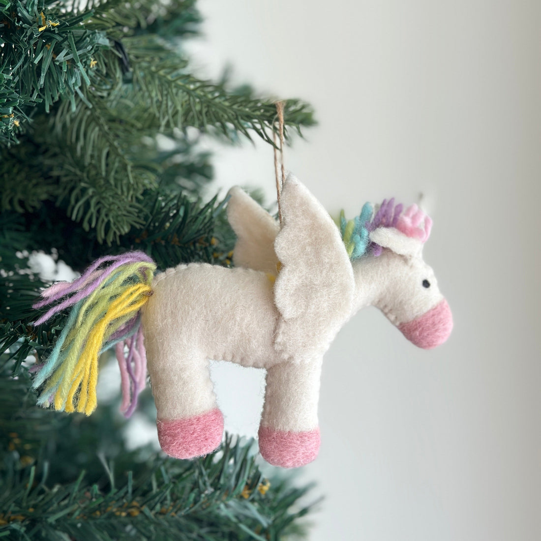 Felt Ornament - Pastel Unicorn, a wool felt ornament by Ganapati Crafts Co., needle-felted and hand-stitched in Nepal