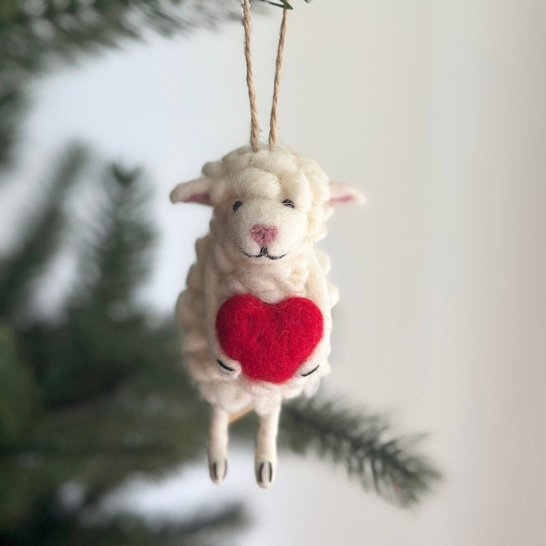 Felt Sheep Holding Heart Ornament, a wool felt ornament by Ganapati Crafts Co., needle-felted and hand-stitched in Nepal
