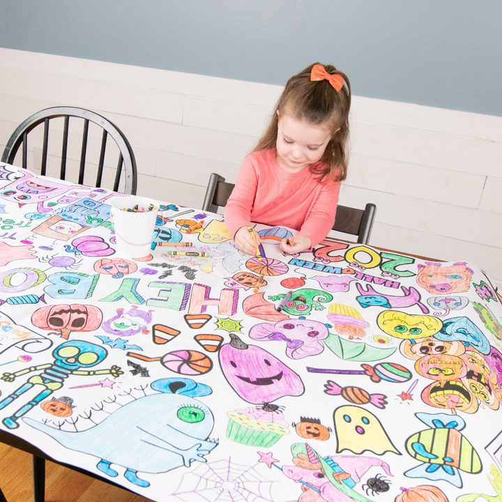 Giant Halloween coloring tablecloth for kids printed with pumpkins, ghosts, and a haunted house