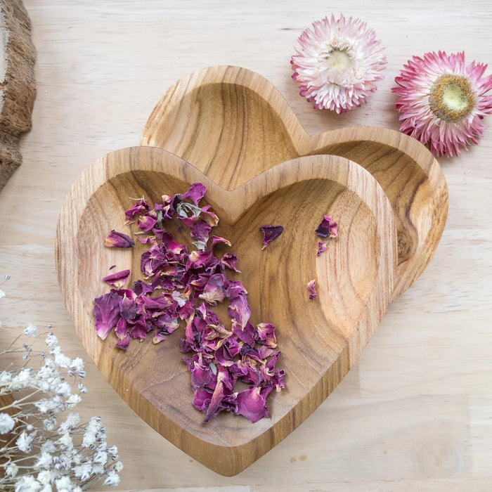 A Papoose heart-shaped teak bowl for holding petals and small dry ingredients