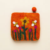 Orange hand-felted wool purse with a zip and felt-ball pull, a yellow sunflower, two felt bees and pink flowers on the front · view 1