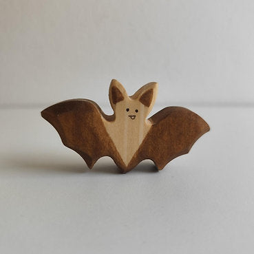 Juharka wooden bat with wings spread wide and the grain left bare across the wings