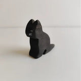 Juharka wooden black cat sitting upright with its tail curled around its feet · view 1