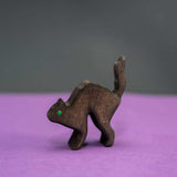 Wooden black cat with an arched back and a single green eye · view 1