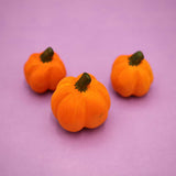 Three plain wooden pumpkins with carved ribs and dark stems · view 1