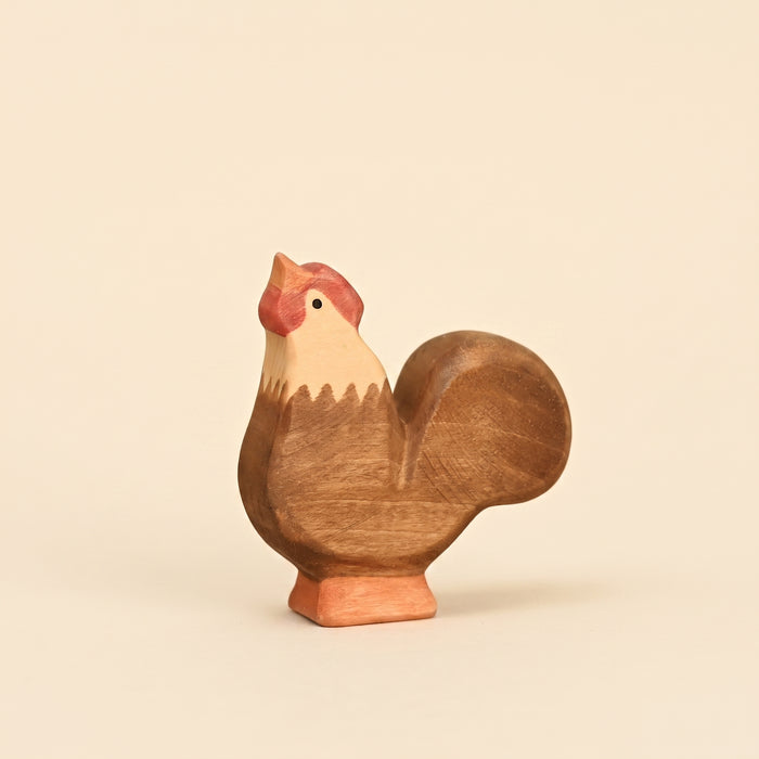 Mako Toys wooden rooster with a red comb and upright tail, standing on a painted base