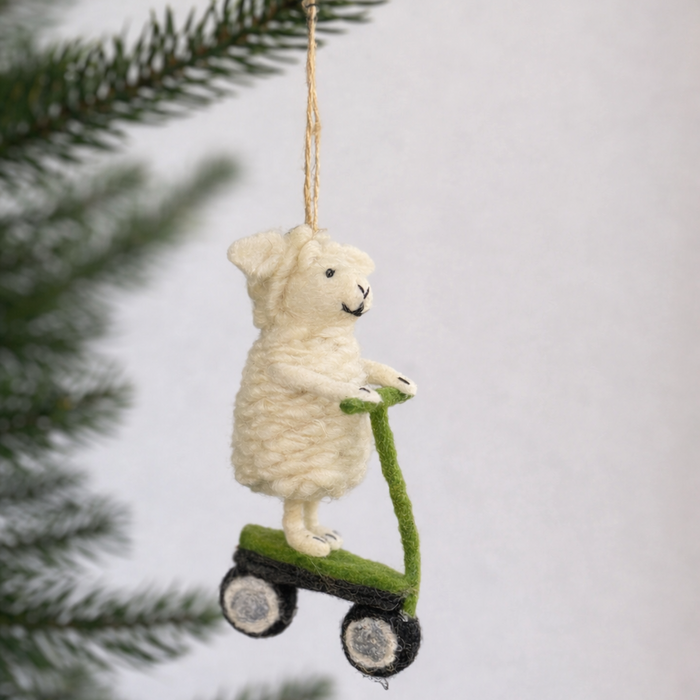 Handmade felt lamb ornament riding a green scooter